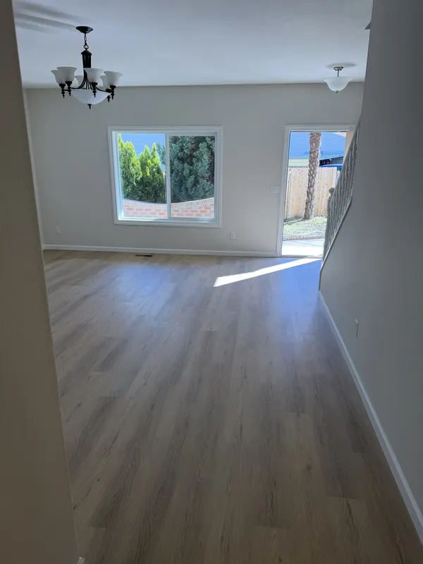 Greige plank carried through an open plan kitchen and dining room