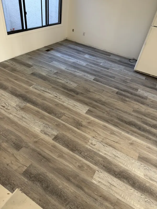 Grey laminate running down a hallway towards a bedroom door