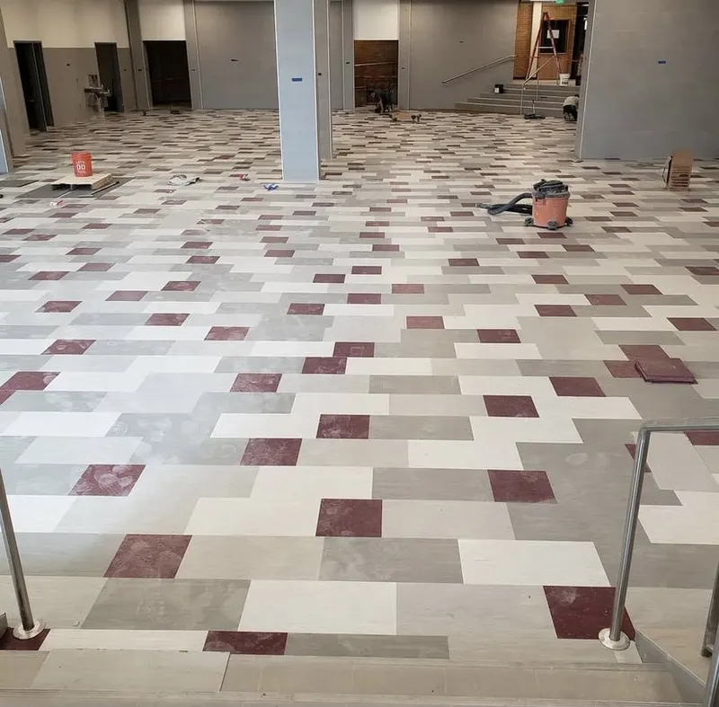 Patterned vinyl tile laid in blocks across a large commercial floor